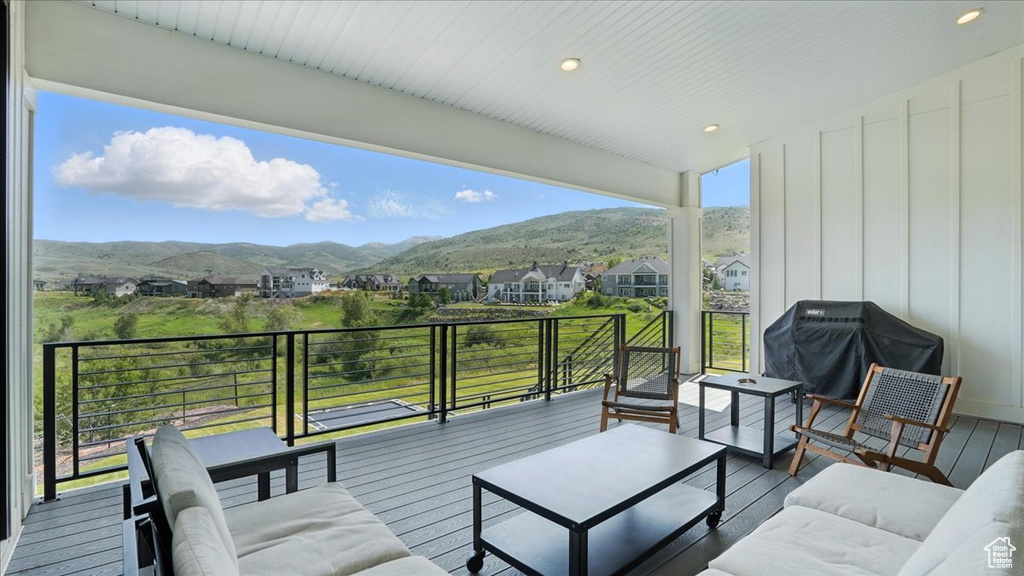 Deck with a grill, a mountain view, outdoor lounge area, and a residential view