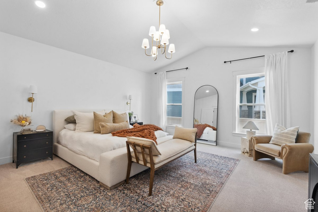 Carpeted bedroom featuring vaulted ceiling, a chandelier, and recessed lighting