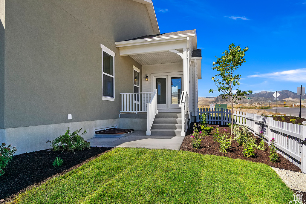 Entrance to property with a mountain view and stucco siding