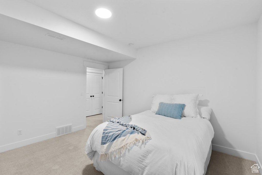 Carpeted bedroom featuring baseboards