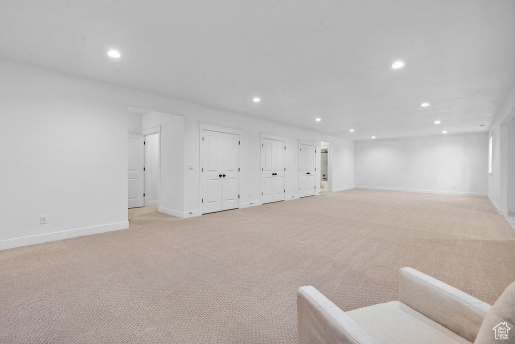 Basement with recessed lighting and light colored carpet