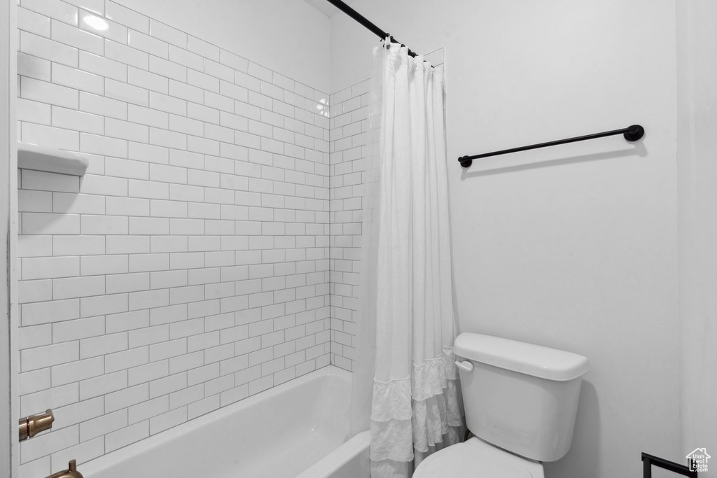 Full bathroom with shower / bath combo and toilet