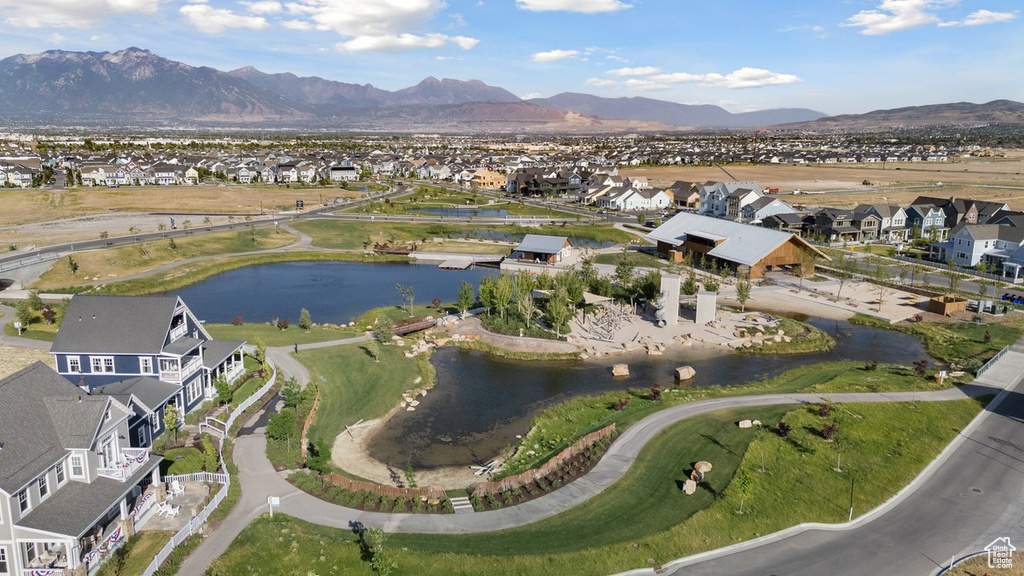 Aerial view of property's location featuring nearby suburban area and a water and mountain view
