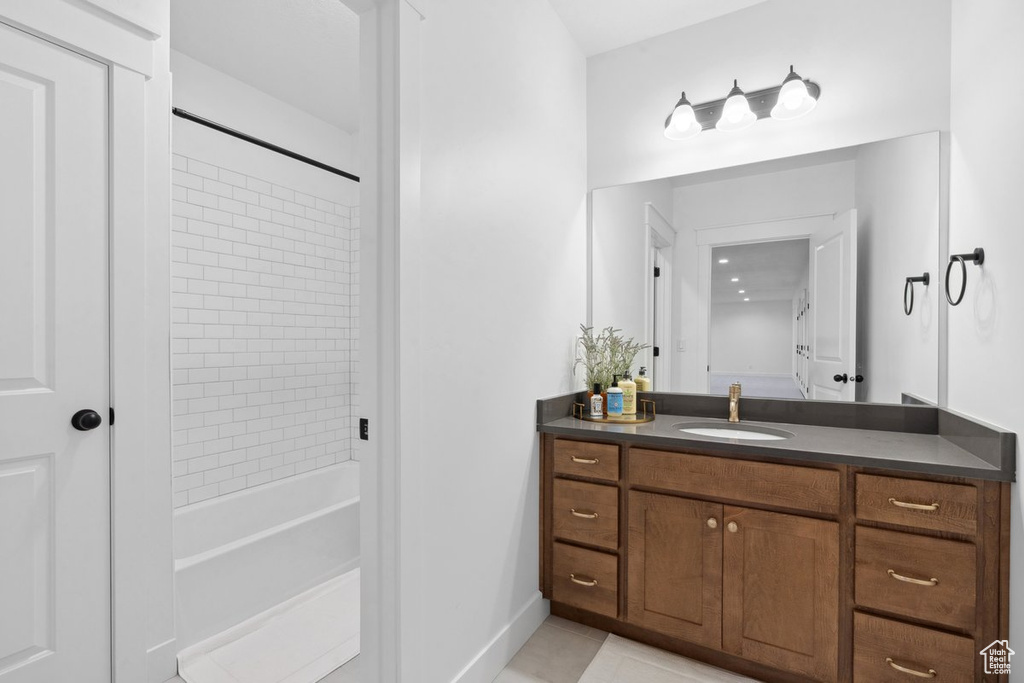 Bathroom featuring vanity,  shower combination, and tile patterned floors