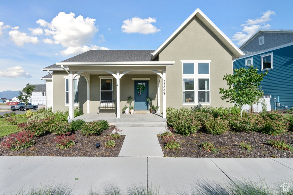 View of front of property featuring a porch and stucco siding