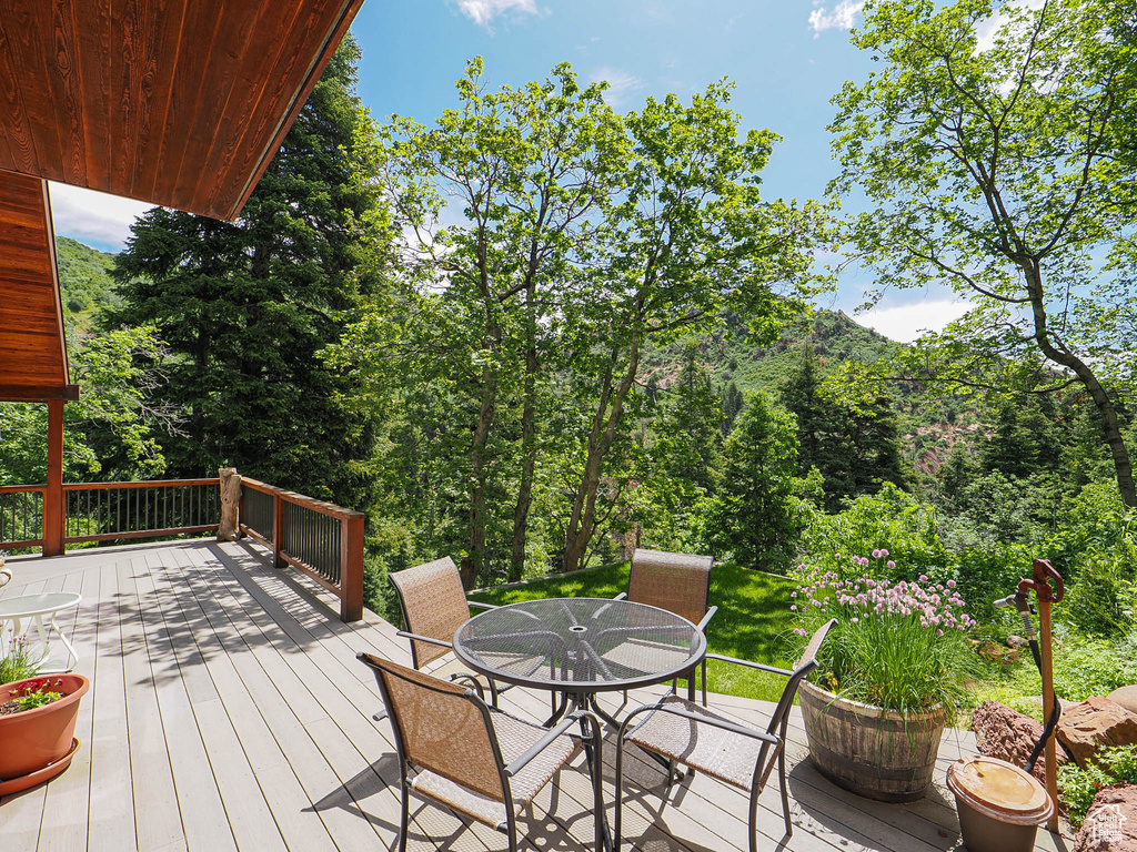 Wooden deck featuring outdoor dining space