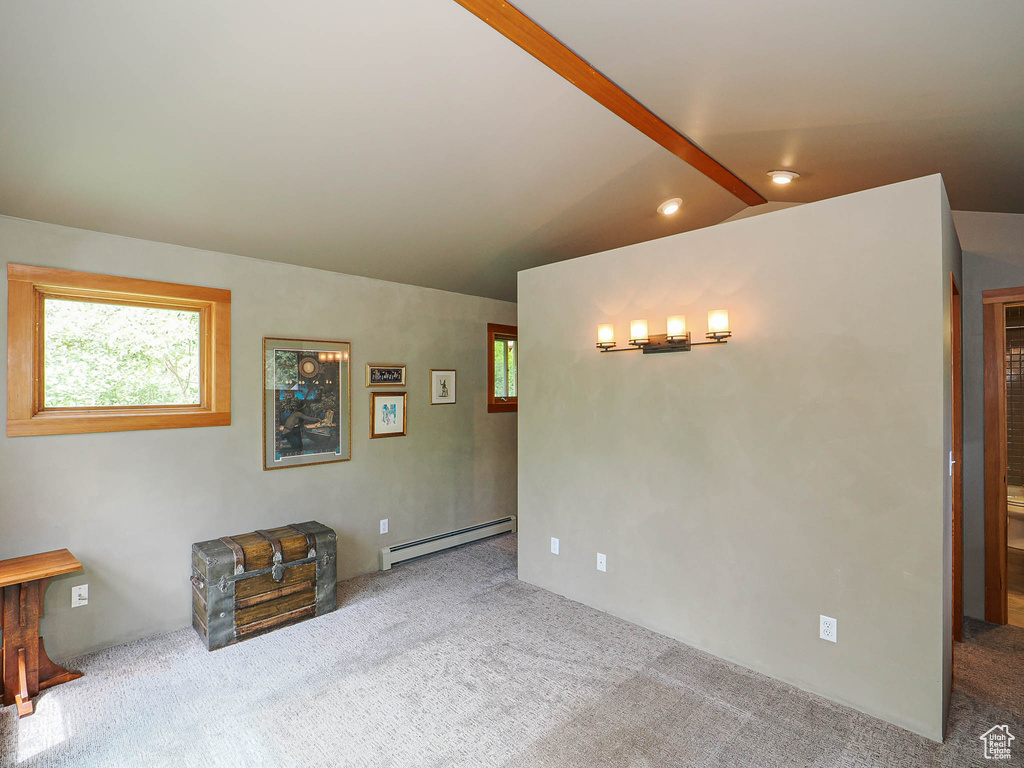 Carpeted empty room featuring baseboard heating, recessed lighting, and lofted ceiling