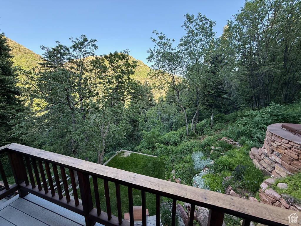 Deck featuring a wooded view