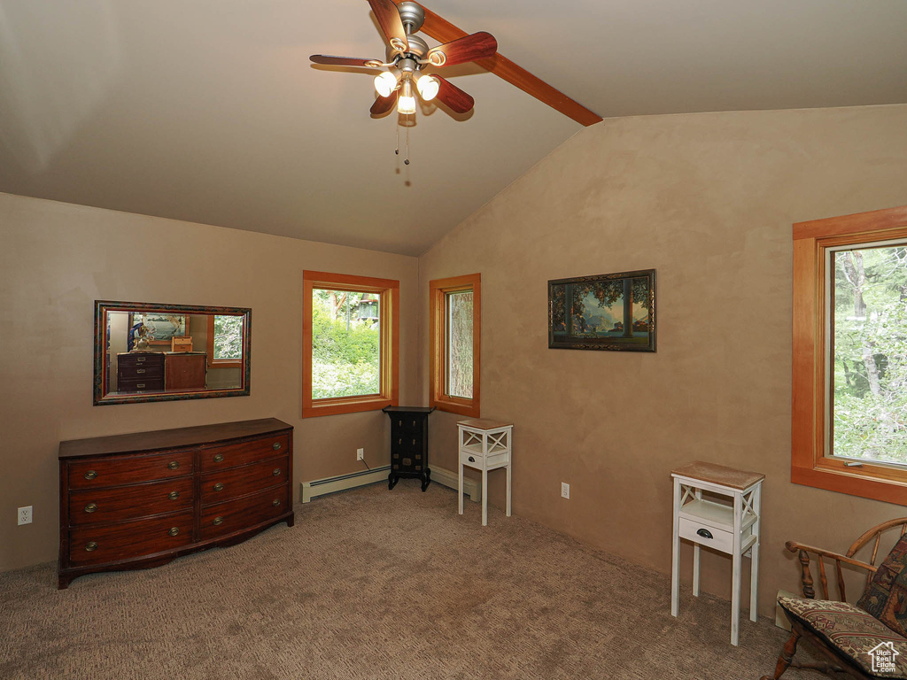 Living area with a baseboard heating unit, a ceiling fan, and carpet flooring