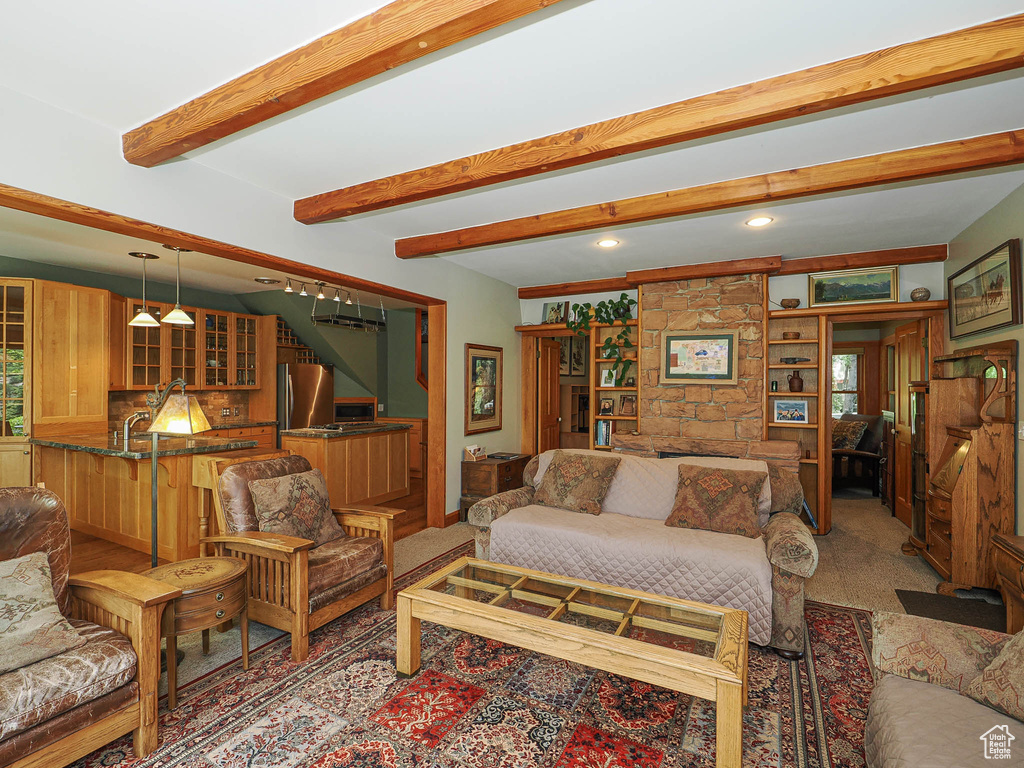 Living area with beam ceiling, light carpet, recessed lighting, and stairway