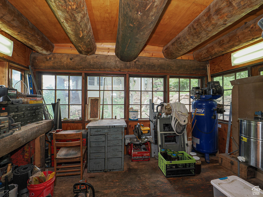 Misc room with a workshop area and beamed ceiling
