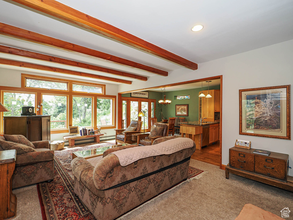 Living area featuring beam ceiling, recessed lighting, and a chandelier