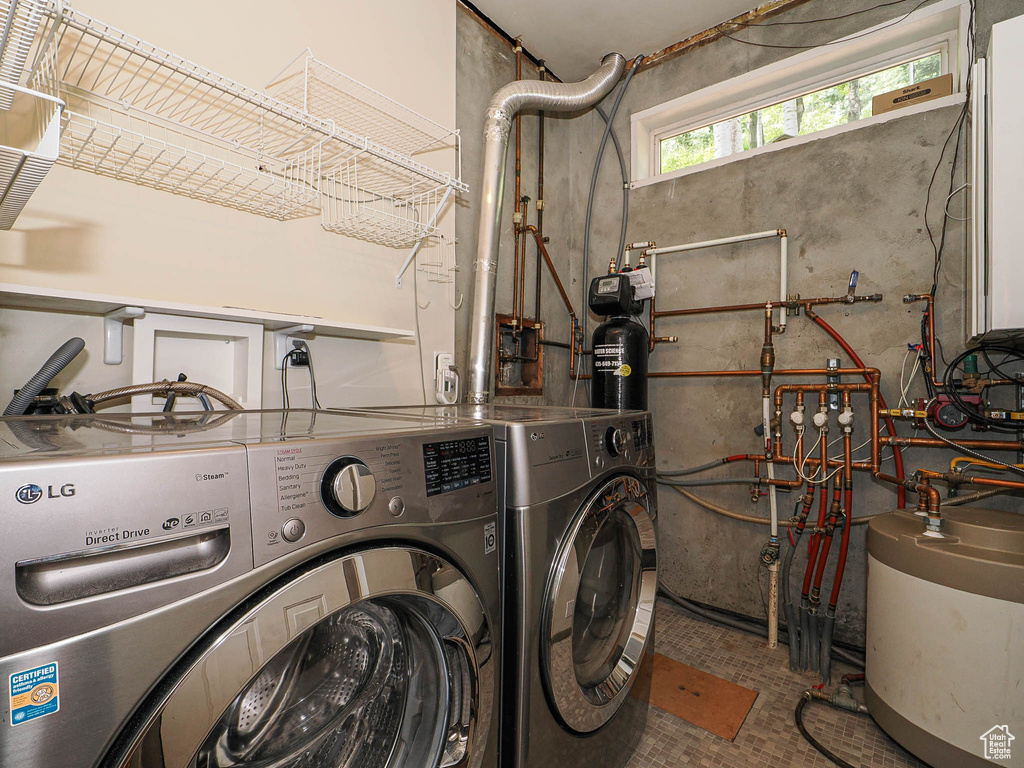 Laundry area with washer and dryer and water heater