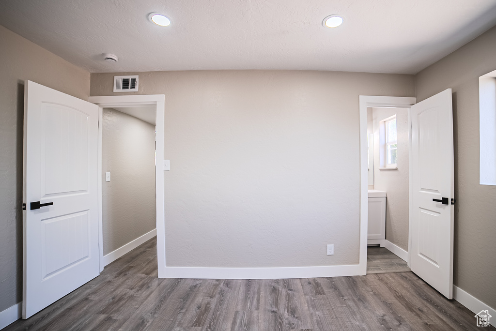 Unfurnished bedroom with wood finished floors and recessed lighting