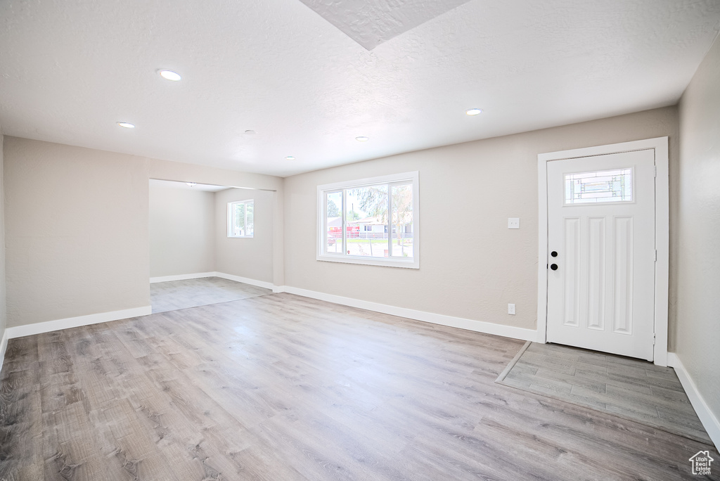 Entrance foyer with wood finished floors and recessed lighting