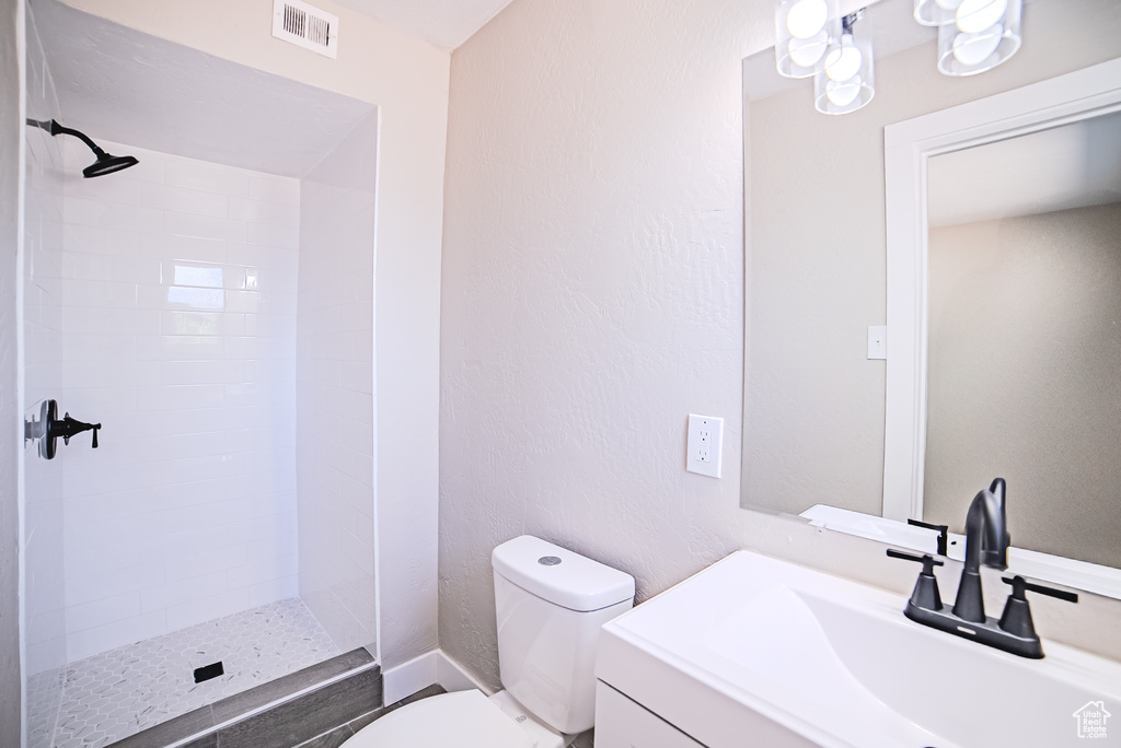 Bathroom featuring vanity and tiled shower