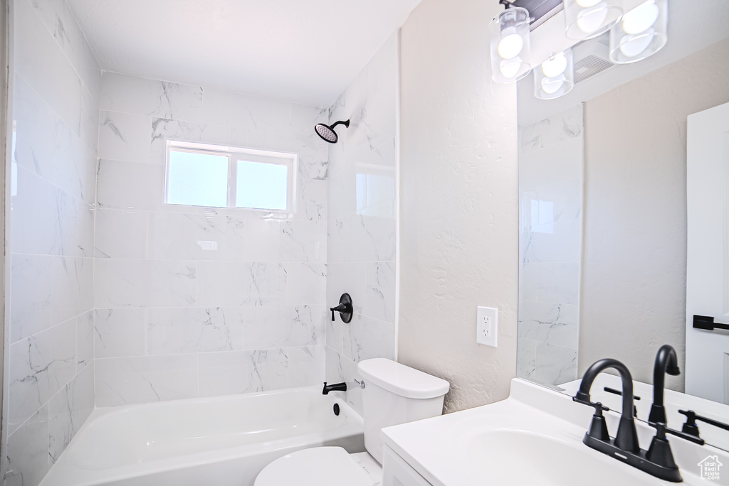 Full bath with vanity, washtub / shower combination, and a textured wall