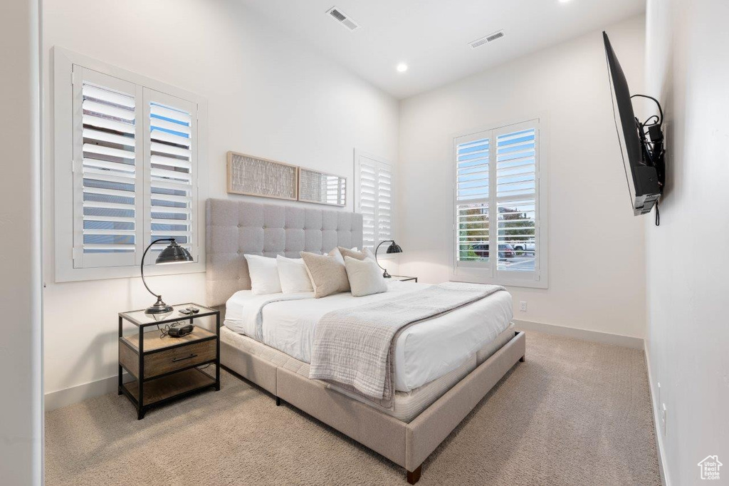 Carpeted bedroom with baseboards and recessed lighting