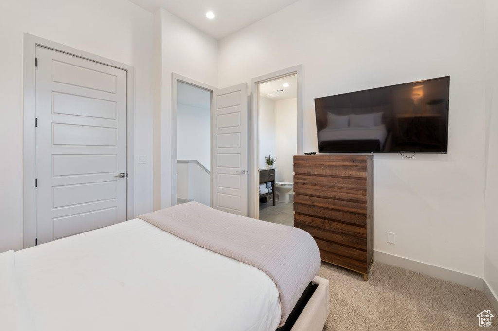Bedroom with light carpet, recessed lighting, and ensuite bathroom