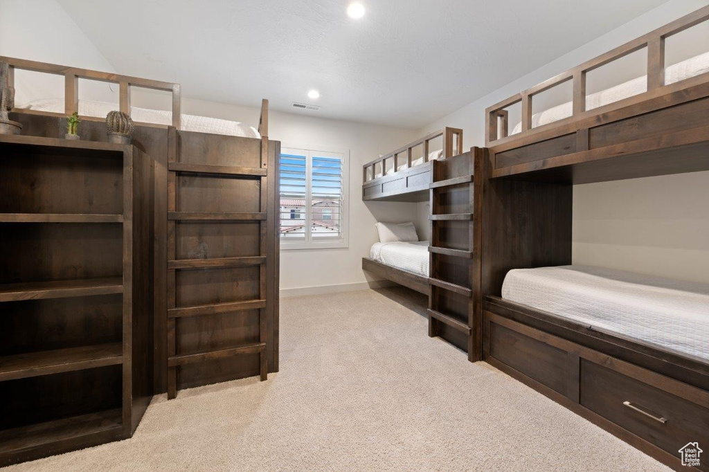 Bedroom with light carpet and recessed lighting