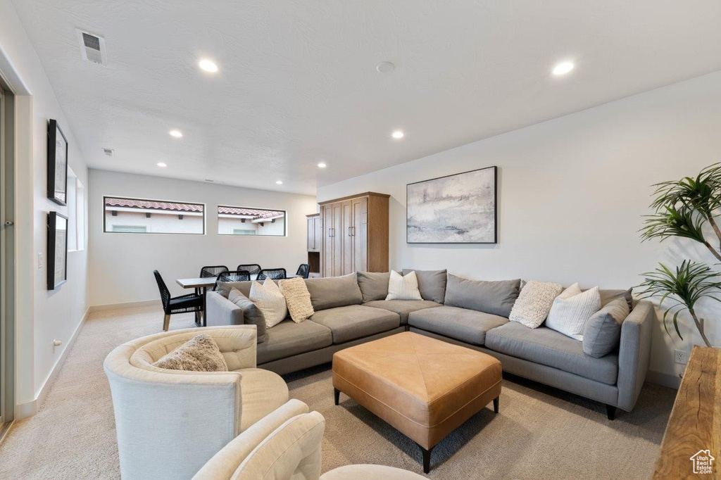 Living area featuring recessed lighting and light colored carpet