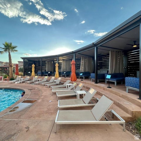 Community pool with a patio area and ceiling fan