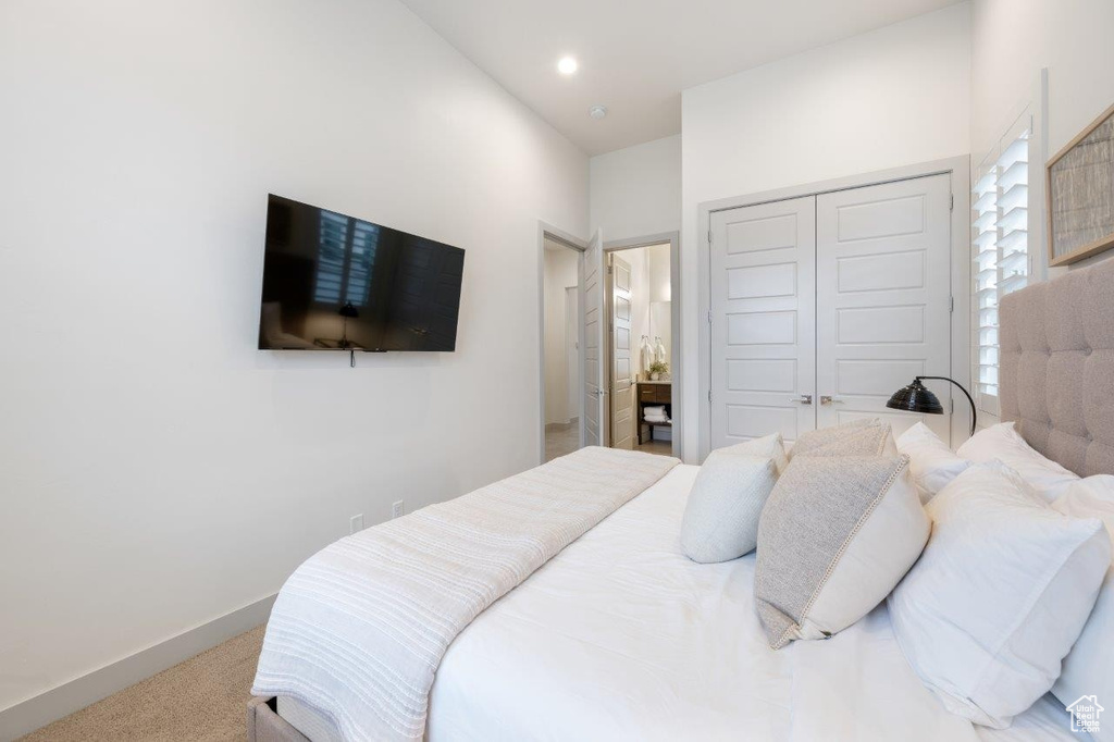 Bedroom with carpet flooring, a closet, and recessed lighting
