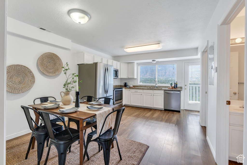 Dining area featuring wood finished floors and baseboards