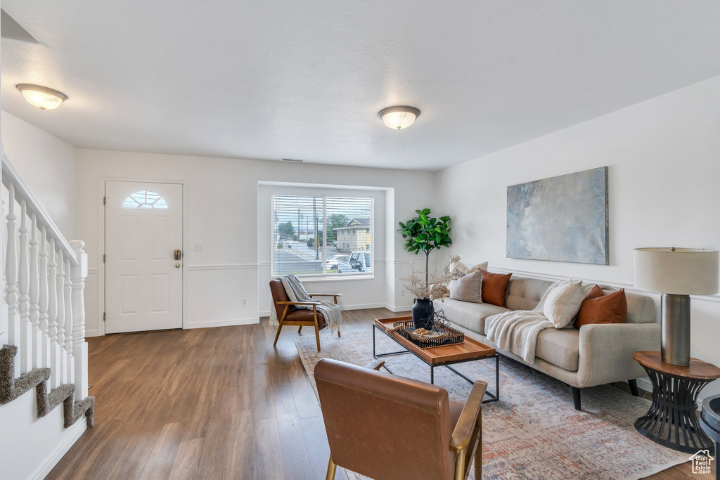 Living area featuring wood finished floors and stairway