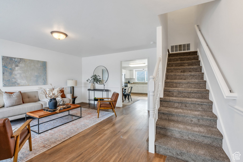 Living area with wood finished floors and stairway