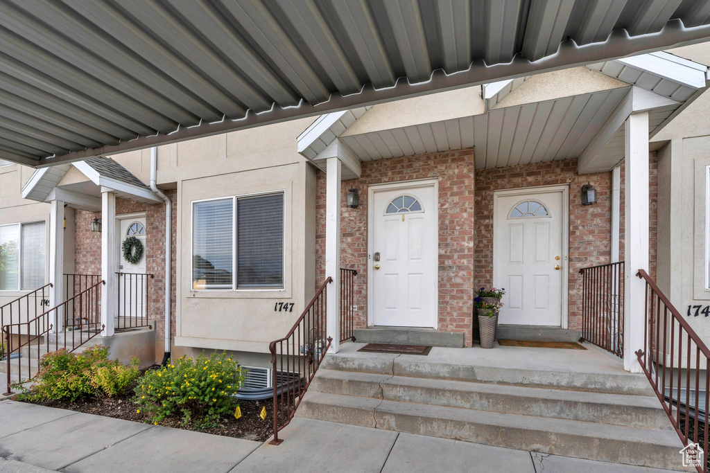 Property entrance featuring brick siding