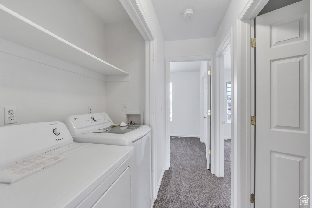 Laundry area with carpet and independent washer and dryer