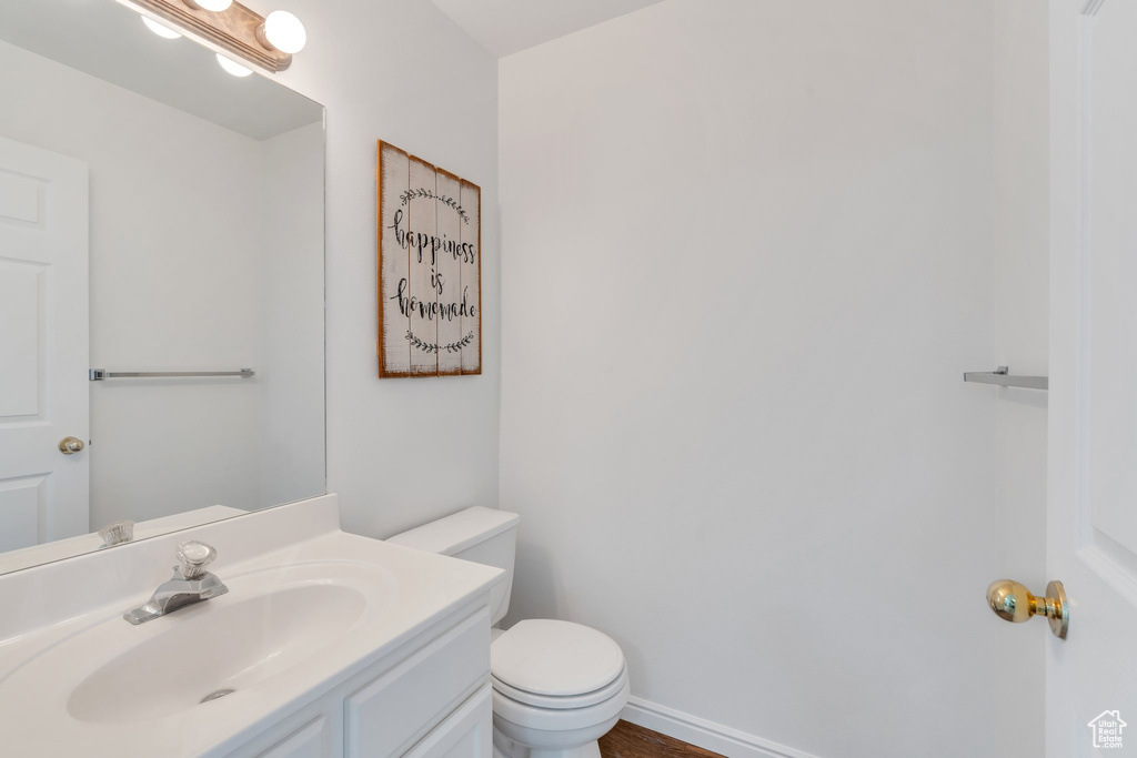 Half bath featuring toilet and vanity