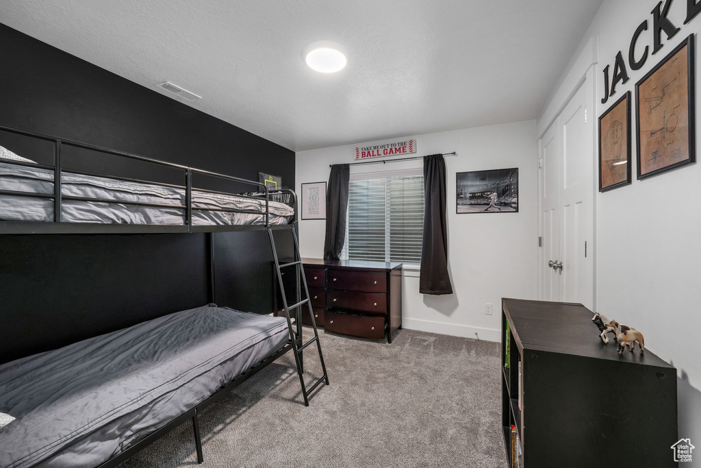 Carpeted bedroom with baseboards