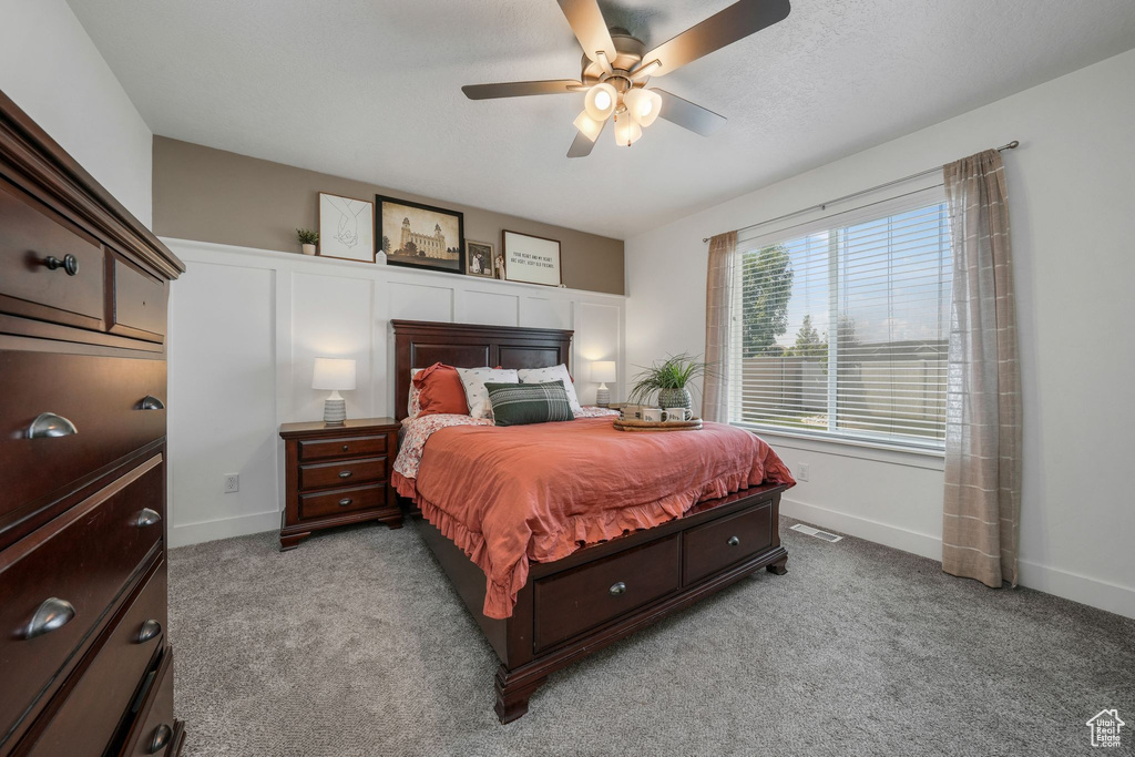 Carpeted bedroom with baseboards and ceiling fan