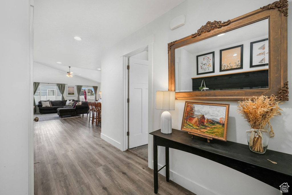 Hall featuring wood finished floors and recessed lighting