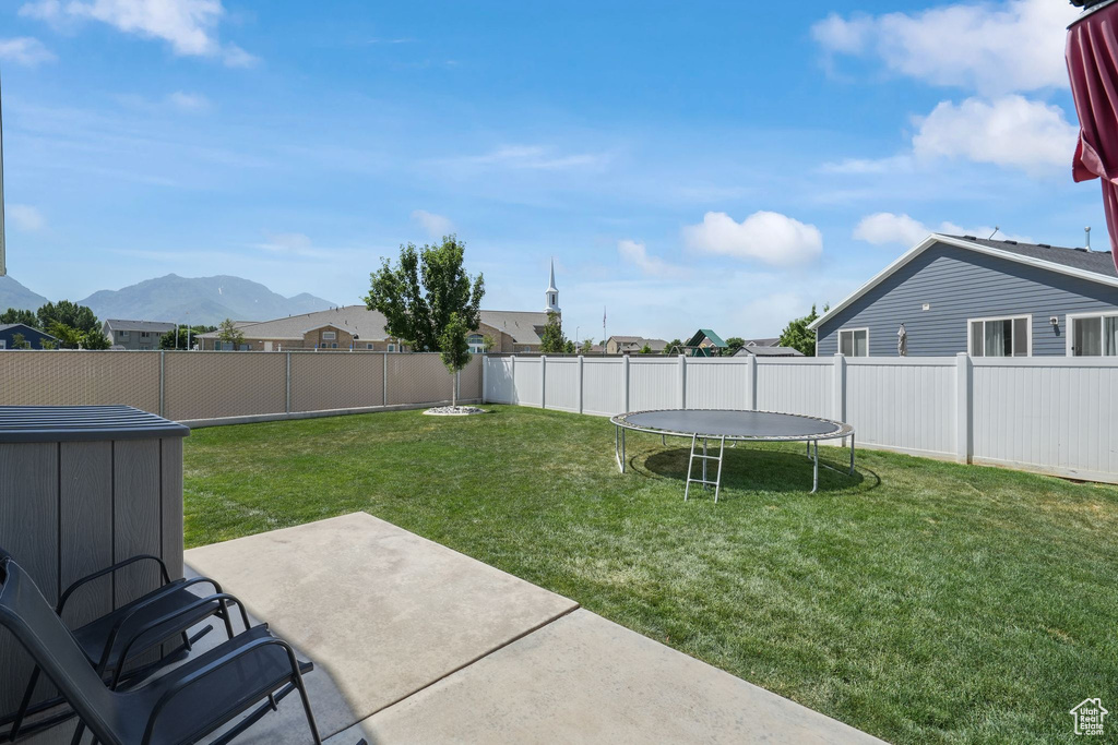 Fenced backyard with a patio and a mountain view