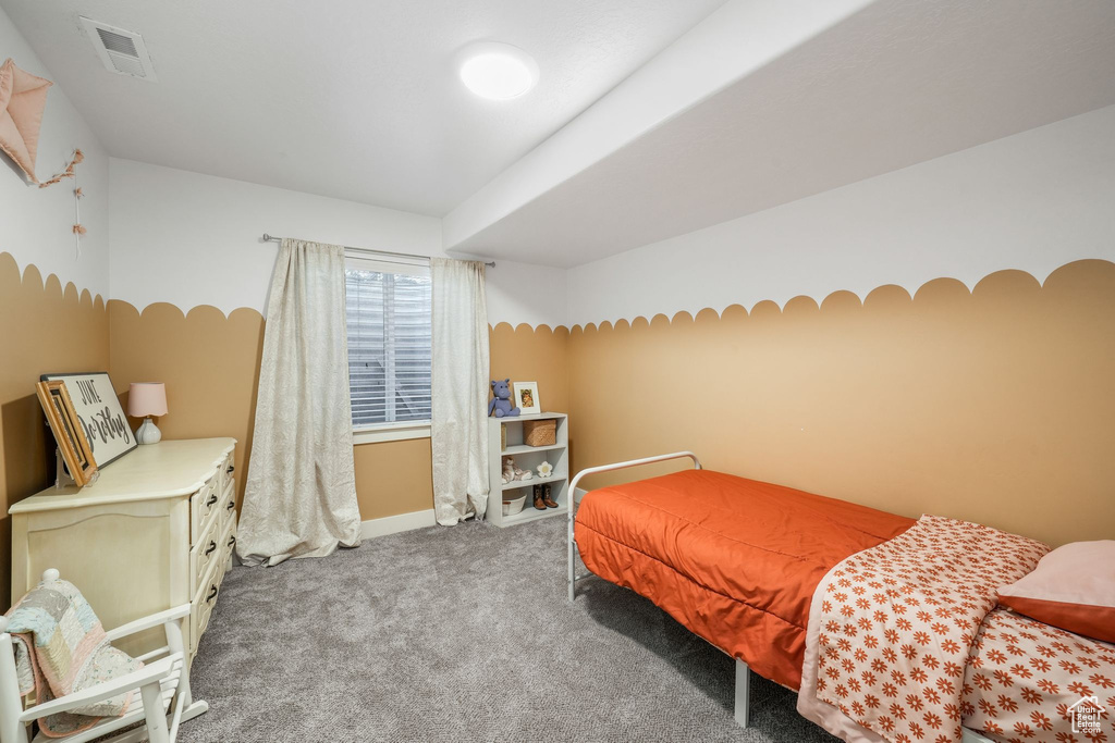 Carpeted bedroom featuring baseboards
