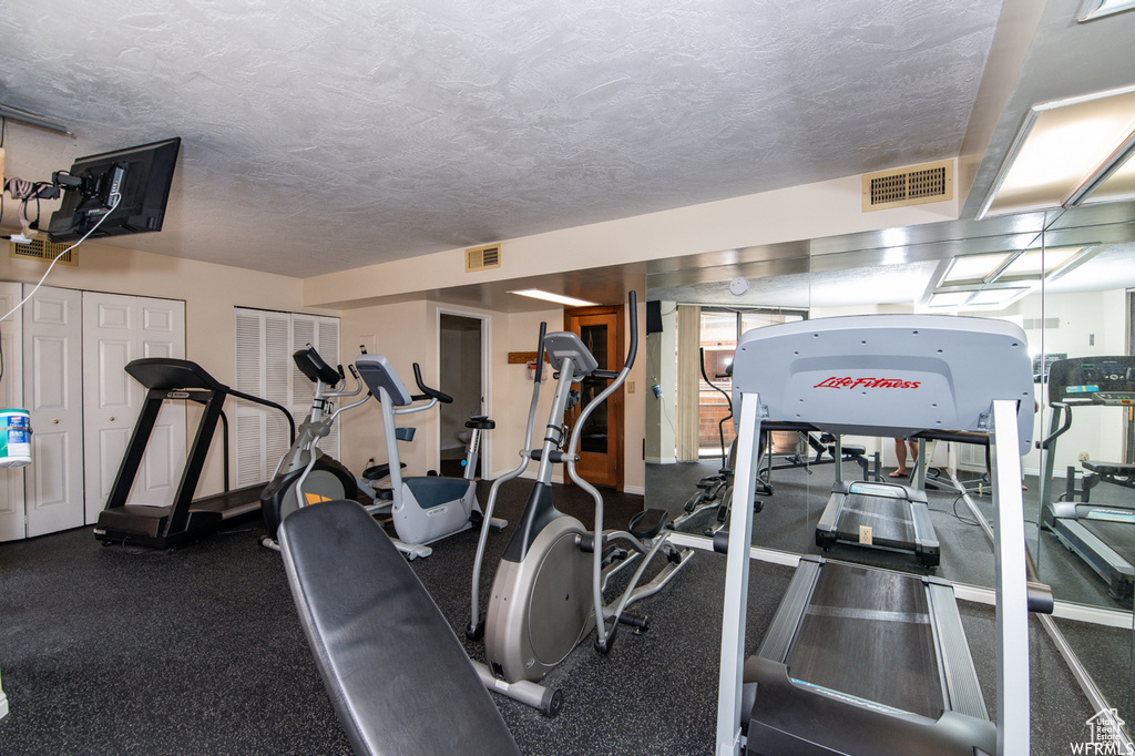 Workout area featuring a textured ceiling