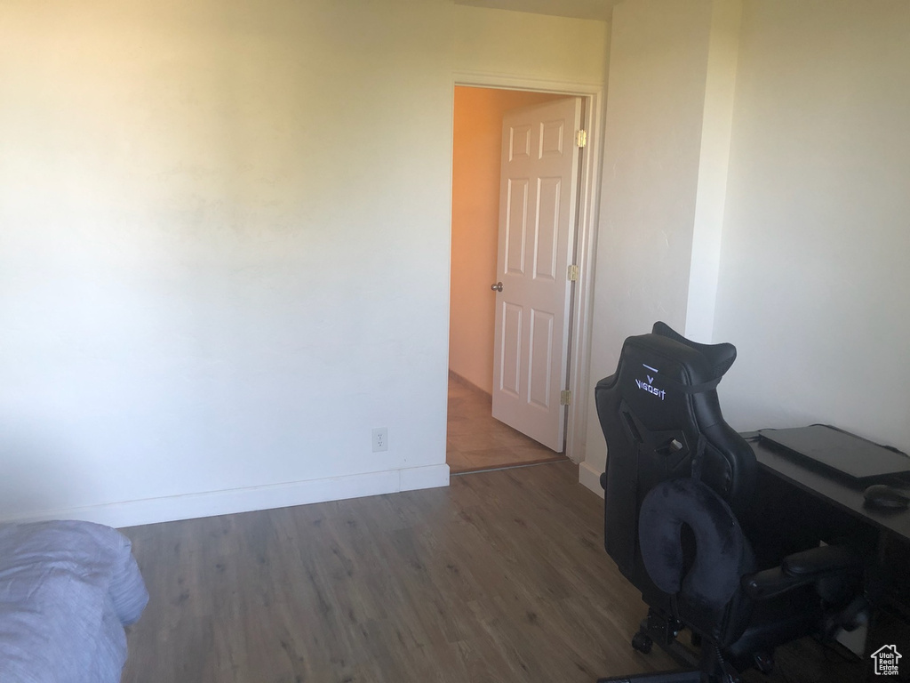 Home office featuring wood finished floors and baseboards
