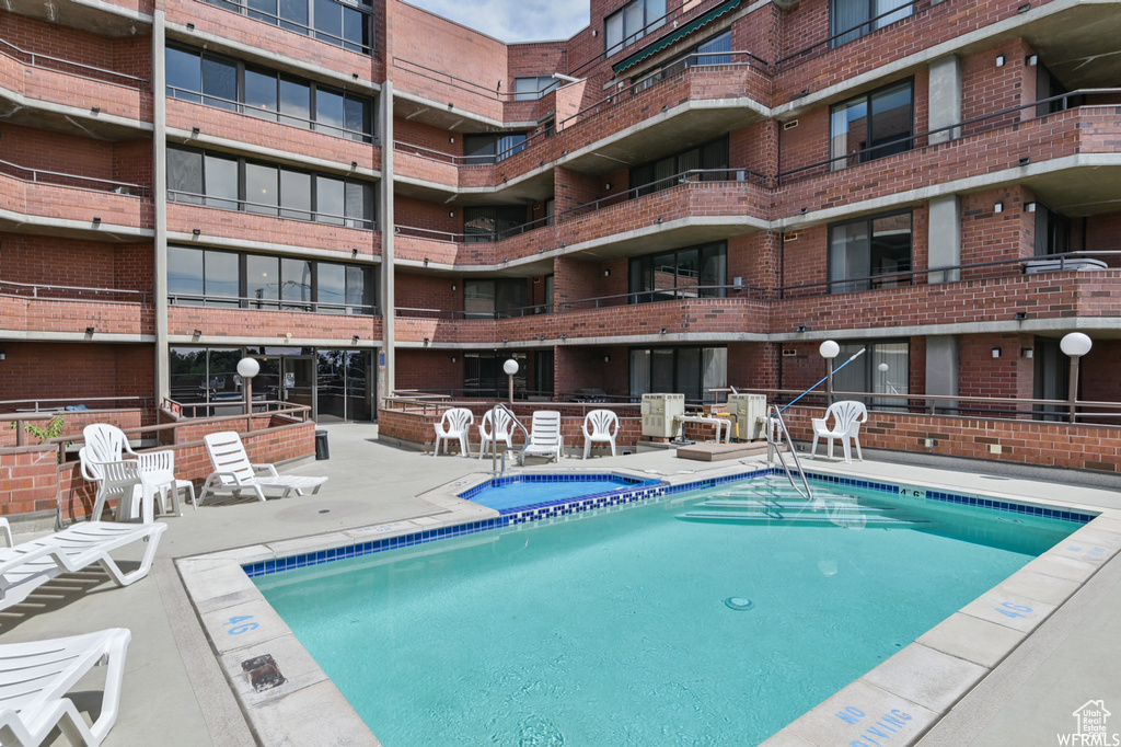 Community pool with a patio