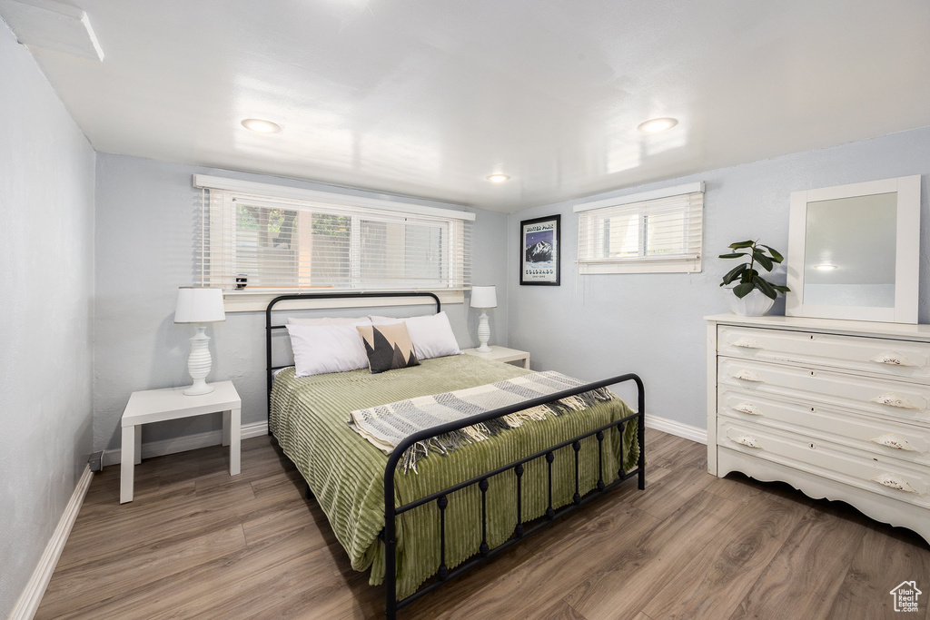 Bedroom with wood finished floors and recessed lighting