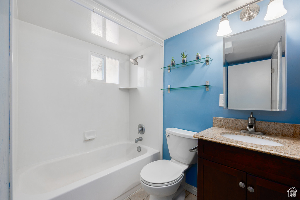 Full bathroom featuring vanity, washtub / shower combination, and tile patterned floors