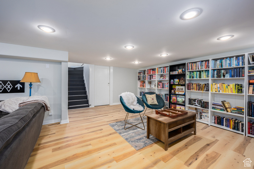 Living area with light wood-style floors, stairway, and recessed lighting