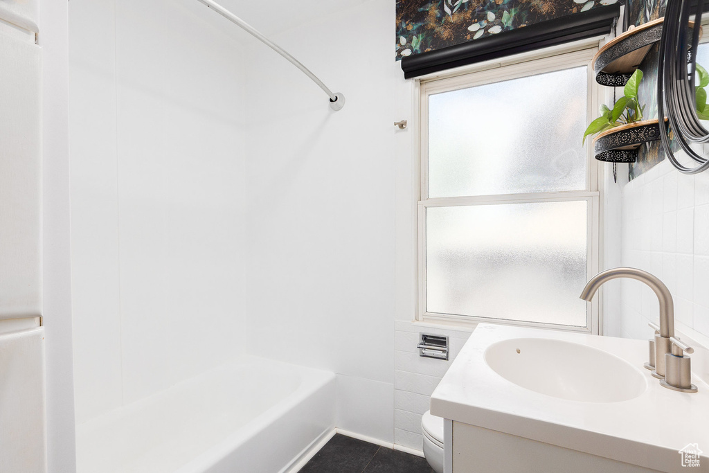 Full bath with plenty of natural light, vanity, shower / bath combination, and tile patterned floors