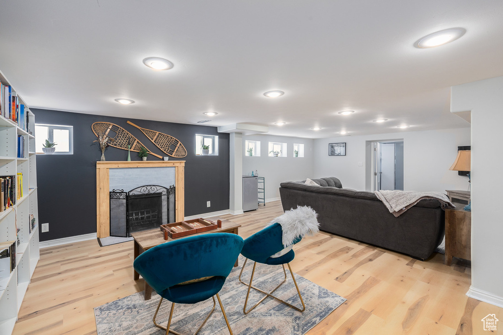 Living room featuring light wood-type flooring and a brick fireplace
