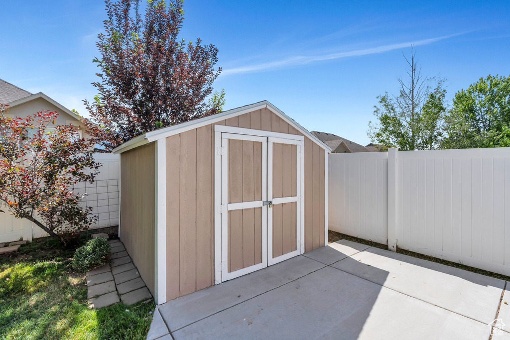 View of shed with a fenced backyard