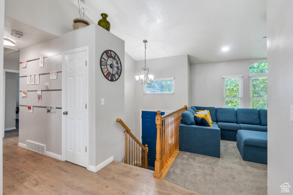 Living area with wood finished floors and a chandelier