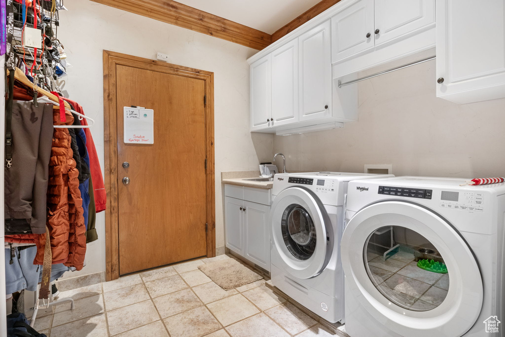 Washroom with cabinet space and washer and dryer
