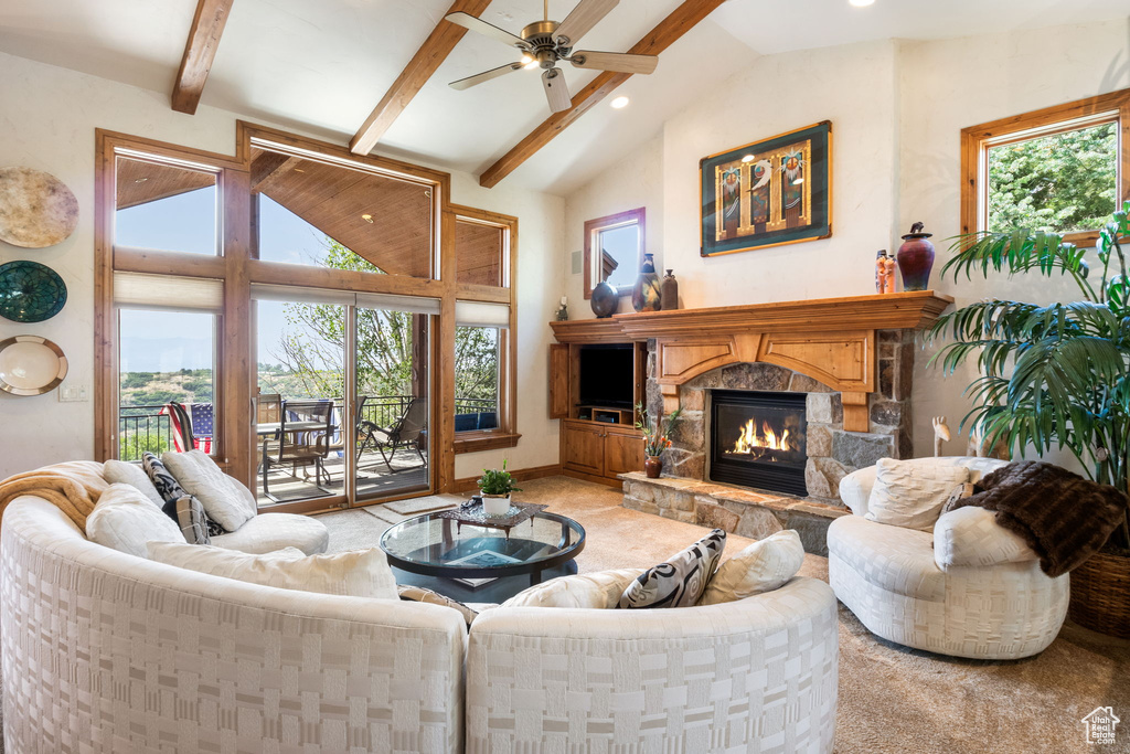 Living room with a fireplace, ceiling fan, beam ceiling, carpet floors, and recessed lighting